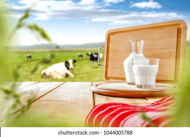 Fresh milk on wooden board and free space for your text or produckt. Spring landscape background.  - Shutterstock ID 1044005788