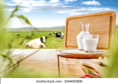 Fresh milk on wooden board and free space for your text or produckt. Spring landscape background.  - Shutterstock ID 1044005800