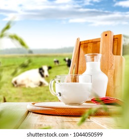 Fresh milk on wooden desk and spring landscape.  - Shutterstock ID 1044050599