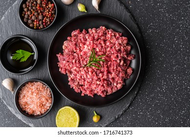 Fresh Minced Meat Ground Beef On A Black Plate Against Stone Background