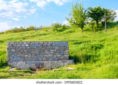 Fresh Mineral Water From A Natural Water Source . Source Of Groundwater . Cross On The Hill Near Water Spring