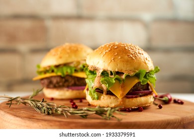 Fresh mini burgers on a deerved tray against a brick wall - Powered by Shutterstock