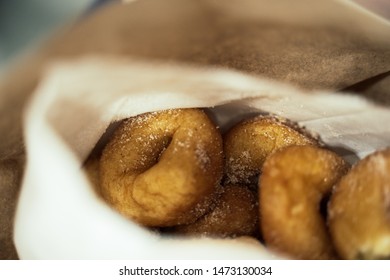 Fresh Mini Donuts With Sugar Sprinkled On Them In A Paper Bag From A Food Stand At The Fair