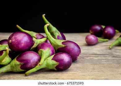 Fresh Mini Purple Eggplant On Wooden Background. Eggplant Has Benefits To Help Build Strong Bones, Prevent Osteoporosis And Cancer, Help Lose Weight And Manage Diabetes.