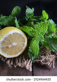 Fresh mint leaf and lemon slice on wooden table , perfect combination for your health.copy space. Selective focus