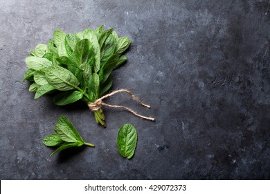 Fresh mint leaves herb on stone table. Top view with copy space - Powered by Shutterstock