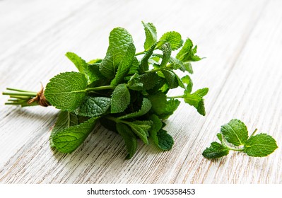 Fresh mint leaves on old wooden  background, flat lay - Powered by Shutterstock