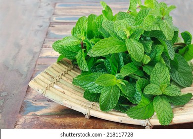  Fresh mint  on wooden table copy space. Selective focus