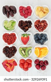 Fresh mixed fruit background selection with fruits high in antioxidants, vitamin c and dietary fibre in heart shaped dishes.