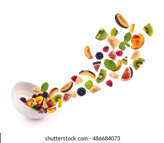 Fresh Mixed Fruits Pieces Falling In White Bowl Of  Fruit Salad Isolated On White