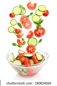 Fresh Mixed Vegetables Falling Into Bowl Of Salad Isolated On White