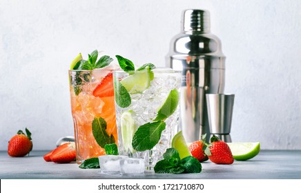 Fresh Mojito cocktail set with lime, mint, strawberry and ice in glass on gray background. Summer cold alcoholic non-alcoholic drinks, beverages and cocktails. Steel bar tools. Copy space