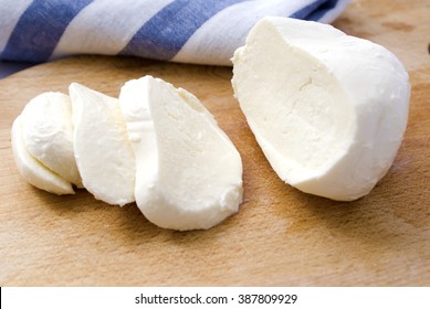 Fresh Mozzarella Cheese Slices On Wooden Cutter