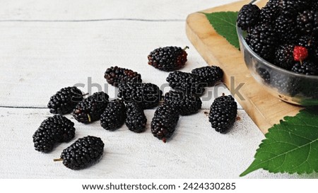 fresh mulberries or murbei (Morus alba), sometimes mistaken as blackberry or blackberries. This type of berry fruit are sweet and sour. Mulberry is black when it's ripe, red when it's still unripe.