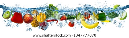 fresh multi fruits and vegetables splashing into blue clear water splash healthy food diet freshness concept isolated on white background