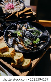 Fresh mussels in creamy sauce with herbs and garlic bread , seafood dish for dining experience