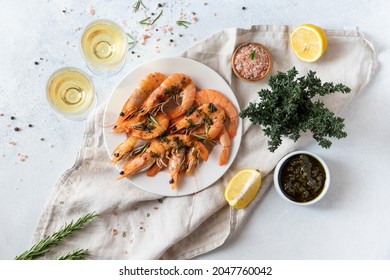 Fresh mussels in a sauce with white wine in transparent glasses. Seafood dinner on a gray background. - Shutterstock ID 2047760042