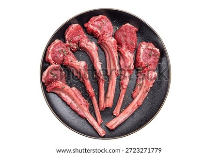Fresh mutton chops, raw lamb meat cutlets on a plate isolated on white background. top view.