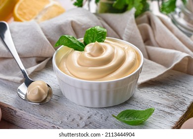 Fresh, natural mayonnaise with basil close-up. Side view, horizontal. Egg sauce - Shutterstock ID 2113444904