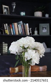 A Fresh, Naturally-lit Peony Bouquet With A Home Bookshelf Backdrop.