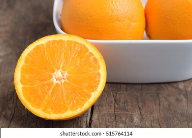 Fresh Navel Oranges In White Bowl On Wood Background  With Copy Space