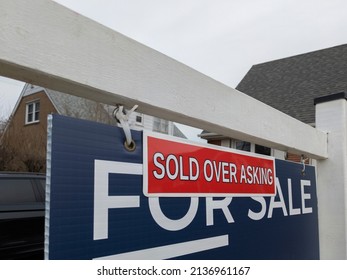 Fresh New Sign Sold Over Asking In Front Of Detached House In Residential Area. Real Estate Bubble, Crash, Hot Housing Market, Overpriced Property, Overpaid, Buyer Activity Concept. Selective Focus.