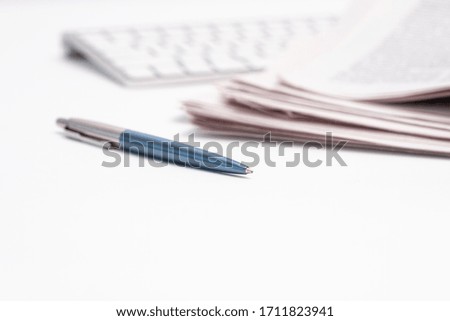 Fresh newspapers on the desktop; white background
