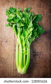 Fresh nice shaped celery on an old grungy kitchen table. - Shutterstock ID 128301626