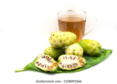 Fresh Noni And Half On Noni Leaf With Healthy Herbal Drink Extracted From Noni Isolated On White Background.