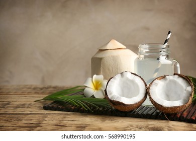 Fresh nuts and mason jar with coconut water on bamboo mat
