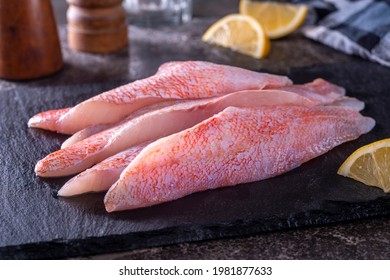 Fresh Ocean Perch Acadian Redfish Fillets On A Slate Board.