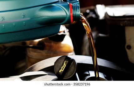 Fresh Oil Being Poured During An Oil Change To A Car