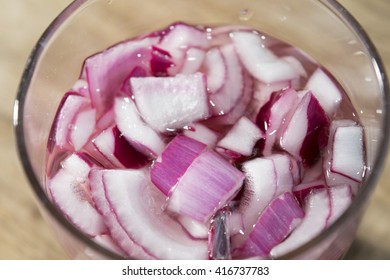 Fresh Onion Typical Of Tropea Cut In Pieces In A Water Glass