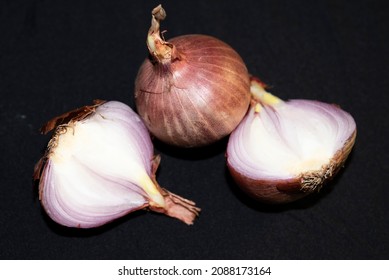 Fresh onion whole and sliced in black background