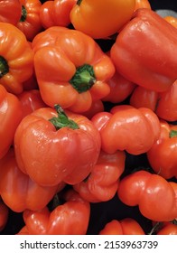 Fresh Orange Capsicum Sold In Supermarket.