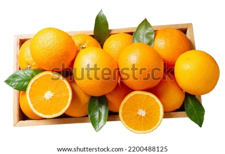 fresh orange fruit with leaves in a wooden box isolated on white background, top view