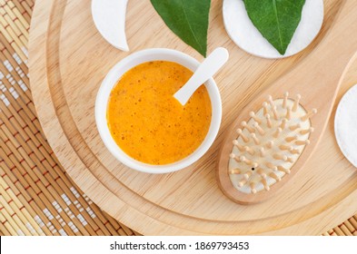 Fresh Orange Fruit Mask (scrub) In A Small White Bowl And Wooden Hairbrush. Homemade Face Or Hair Mask, Natural Beauty Treatment And Spa Recipe. Top View, Copy Space. 