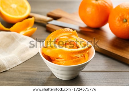 Fresh orange fruit peels on wooden table