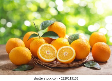 fresh orange fruits with leaves on wooden table