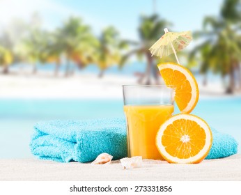 Fresh Orange Juice, Fruits On Sand With Blue Sky Background, Summer Concept 