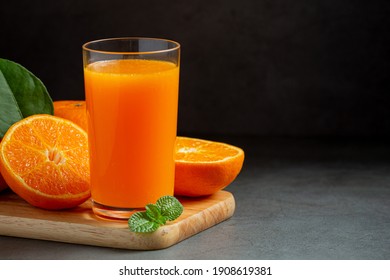 Fresh Orange Juice In The Glass On Dark Background