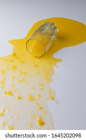 Fresh Orange Juice Spilled On A White Table, With Pulp