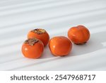 Fresh orange persimmon isolated on white background