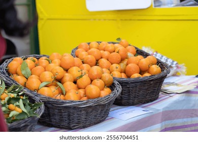 Fresh oranges in wicker baskets at vibrant outdoor market - Powered by Shutterstock