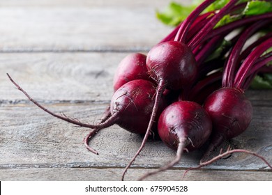 Fresh organic beet, beetroot. Grey rustic wooden background. Close up.