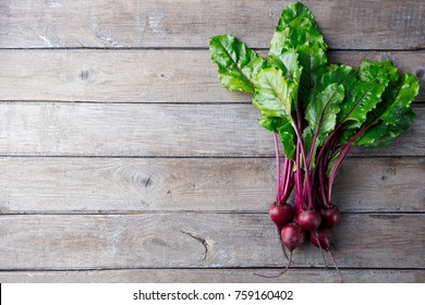 Fresh organic beet, beetroot on grey rustic wooden background. Top view. Copy space.
