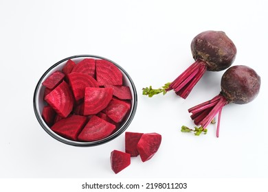 Fresh Organic Beetroot Slices served in a bowl on a white background. This fruit is usually made into juice or salad.
					