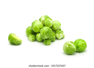 Fresh organic brussels sprouts whole and halves isolated on white background.