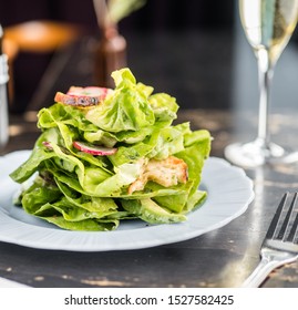 Fresh organic butter leaf lettuce salad with croutons and radish. A light lunch or appetizer served in a French restaurant.