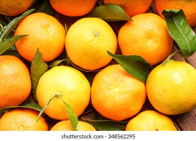fresh organic clementines picked with green leaves - Shutterstock ID 348562295